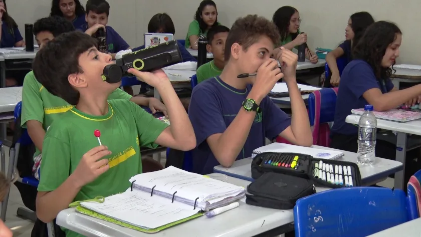 Com o calor intenso, os estudantes agora utilizam garrafinhas de água como um acessório indispensável. - Foto: Reprodução/TVC