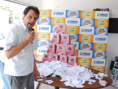 Gil Casanova, coordenador artístico das emissoras do Grupo RCN com os cupons da promoção -
