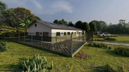 Obras de unidade básica de saúde em aldeia indígena de Dourados, com trabalhadores e estrutura em construção ao fundo