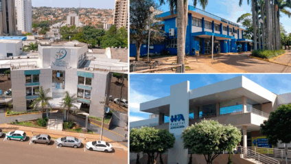 achada de hospital público ao entardecer com viaturas e entrada principal, ambiente urbano desfocado